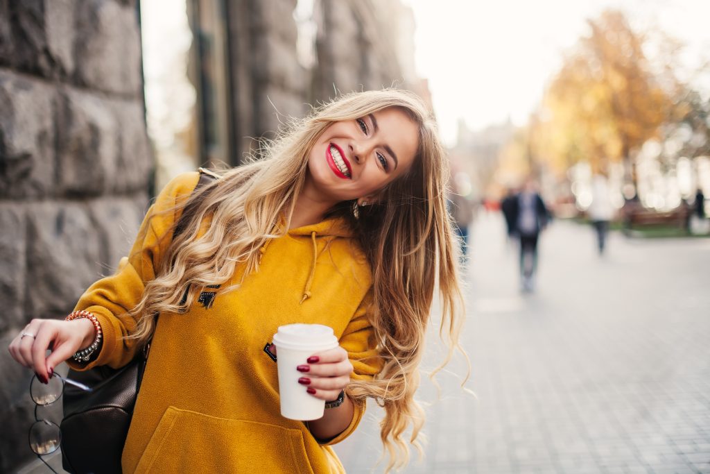 confident young woman showing off her new white smile